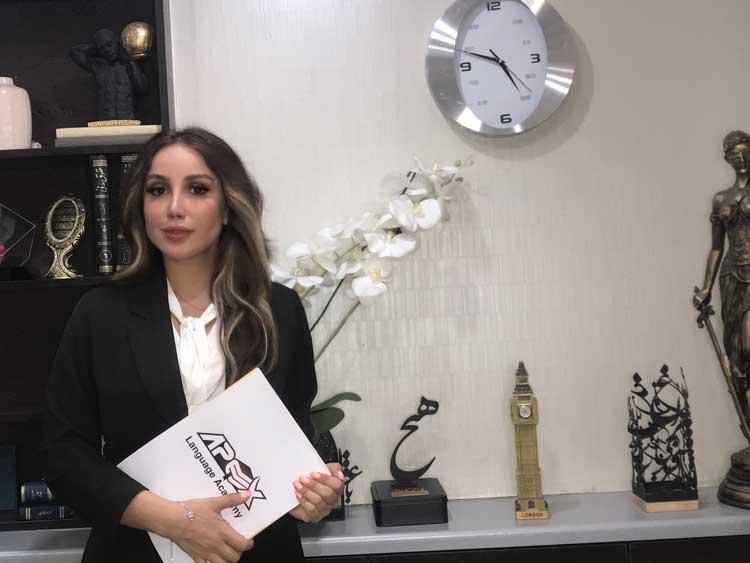 A person holding an Apex Language Academy folder