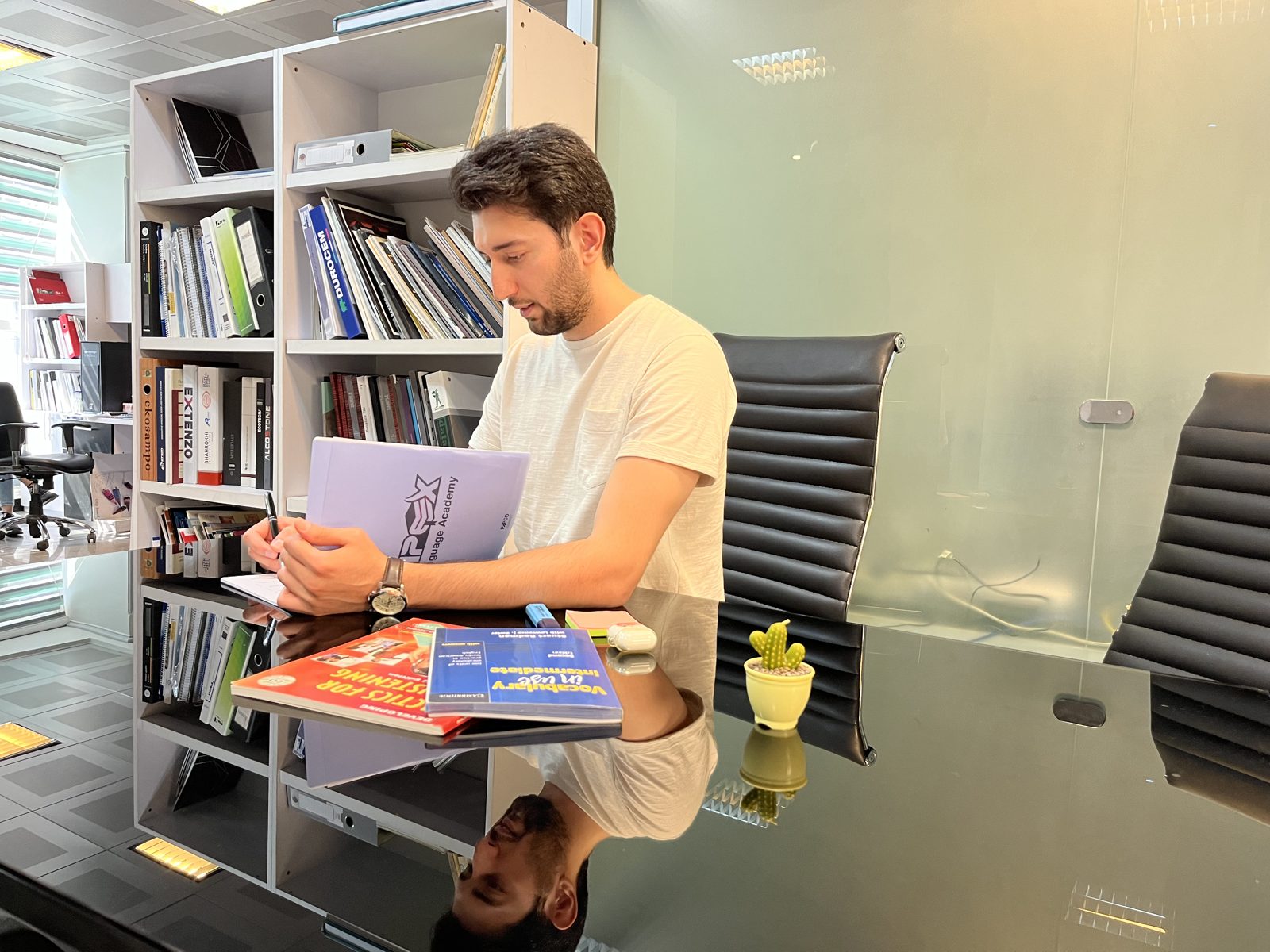 An Apex student taking notes at his desk