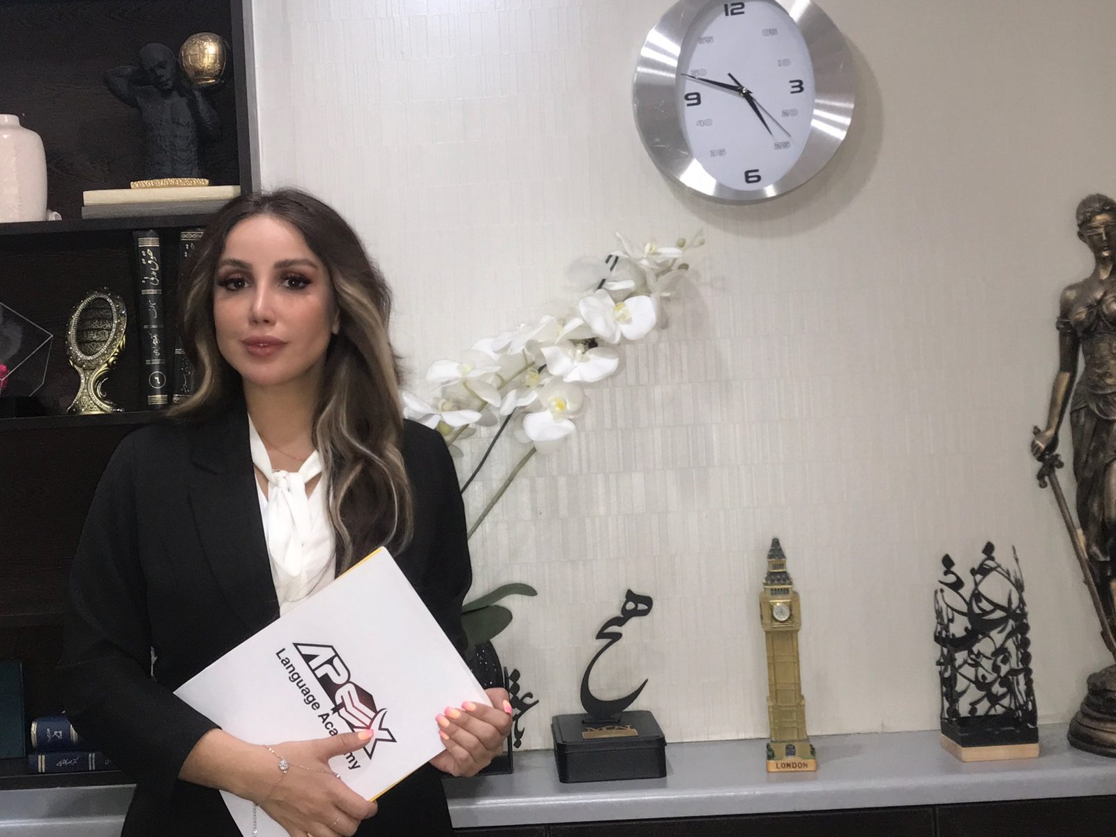 An Apex student holding her Apex course book