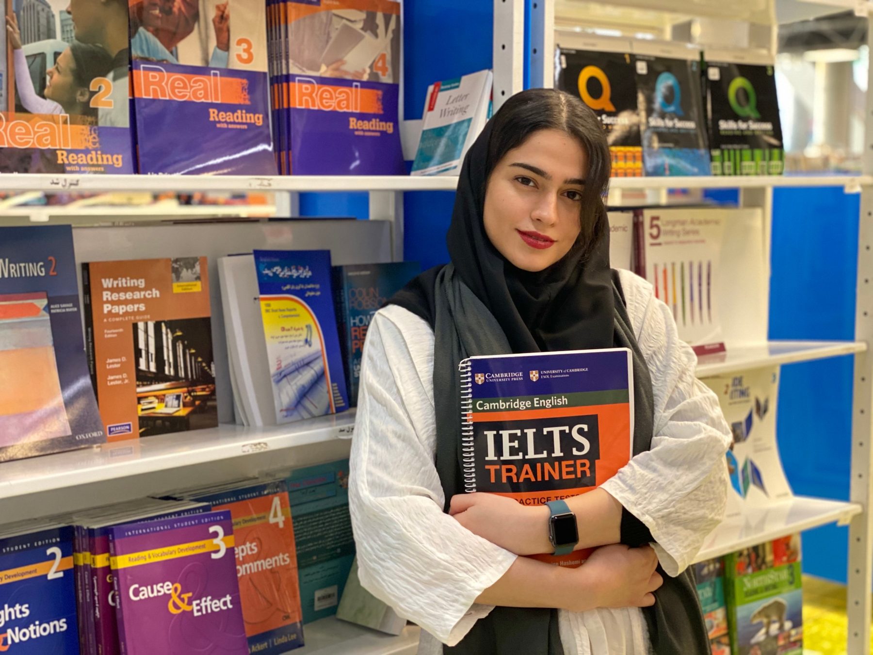 An Apex student with her IELTS Trainer book