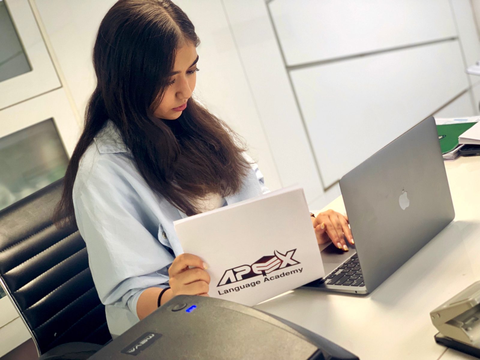 An Apex student working on her laptop