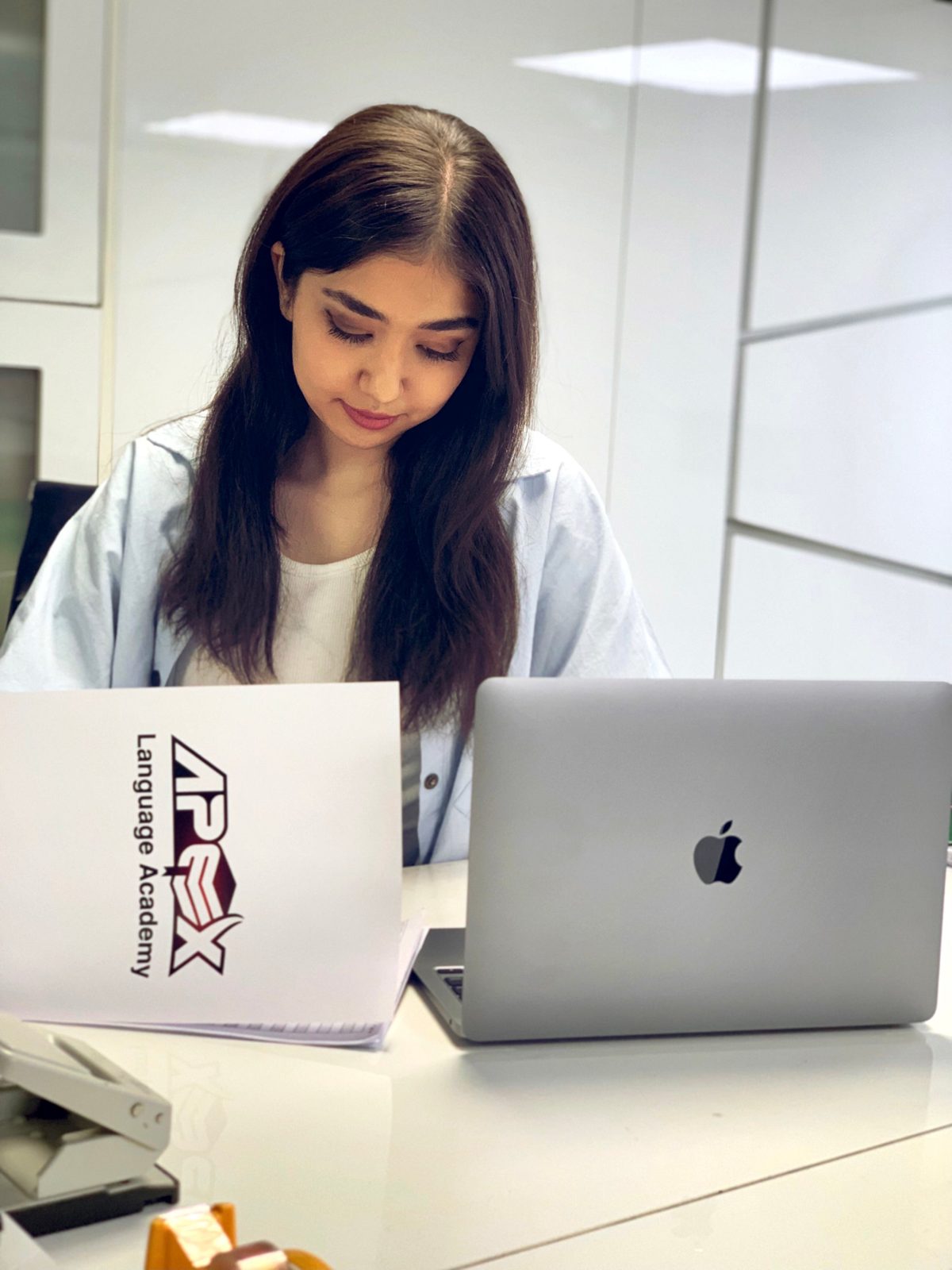 An Apex student working on her laptop