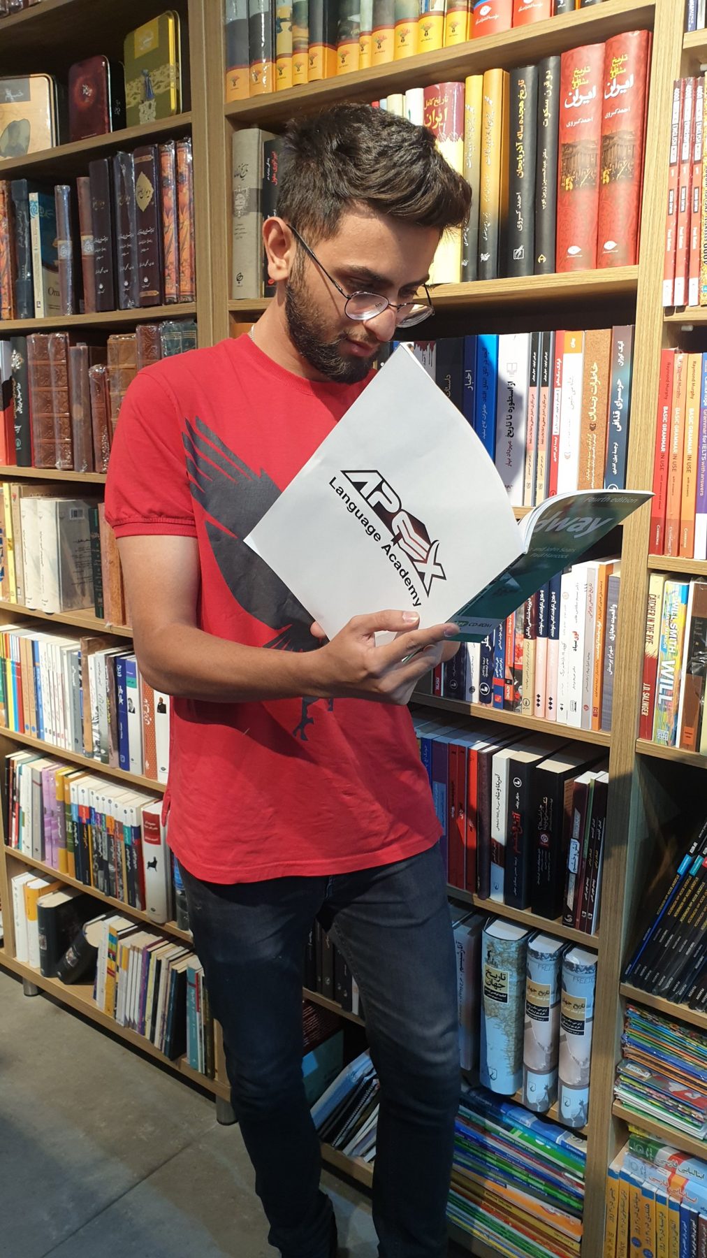 An Apex student reading his Apex course book